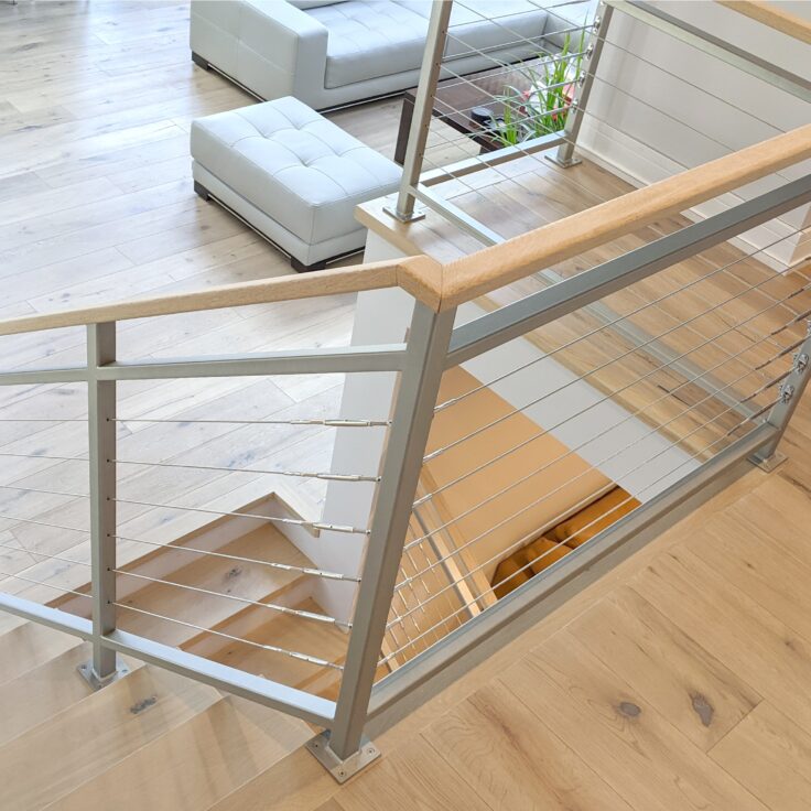 Custom wrought iron & wood & cable railings urban modern painted silver top of stairs view