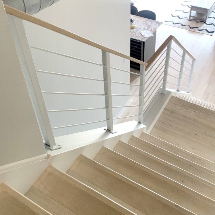 Custom wrought iron & wood railings urban modern painted satin white top stairs view